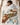 Child sleeping under a Vintage Steamboat Mickey and Minnie Christmas train fleece blanket on a bed