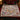 Lamplight Hollow Christmas Village woven blanket spread across a bed in a Christmas bedroom