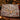 Lamplight Hollow Christmas Village woven blanket draped over a sofa in a holiday living room