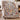 Lamplight Hollow Christmas Village woven blanket draped over an armchair by the fireplace