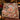Tartan Gingerbread Squirrel Kitchen woven blanket draped over a sofa in a holiday living room