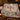 Snowman Moonlit Birch Carnival woven blanket draped over a sofa in a holiday living room