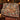 Grandmas Fireside Woodland Homecoming woven blanket draped over a sofa in a holiday living room