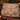Gingerbread Cottage Squirrel Bakery woven blanket draped over a sofa in a holiday living room