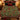 Tartan Spruce Holly Hearth Morris Style Christmas woven blanket spread across a bed in a Christmas bedroom