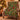Tartan Spruce Holly Hearth Morris Style Christmas woven blanket draped over an armchair