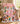 Snoopy and Peanuts Gang Pink Christmas Skating Party fleece blanket draped over a sofa