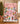 Snoopy and Peanuts Gang Pink Christmas Skating Party fleece blanket spread across a bed in a cozy bedroom