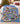 Snoopy and Peanuts Gang Ice Palace Christmas Parade fleece blanket spread across a bed in a cozy bedroom