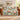 Camellia & Blue Tits woven blanket draped over a brown leather sofa
