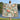 Woman holding a Camellia & Blue Tits woven blanket outdoors by a lake
