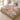 Poppy & Moth Reverie woven blanket spread across a bed in a sunny bedroom