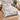 Magnolia & Swallows comforter set with 2 matching pillowcases on a bed in a warm bedroom