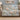 Magnolia & Swallows woven blanket draped over a sofa in a neutral living room