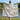 Woman holding a Magnolia & Swallows woven blanket outdoors by a lake