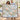 Couple holding a personalized Magnolia & Swallows woven blanket with sample first names in a living room