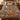 Bloodroot Trout Lily woven blanket spread across a bed in a cozy bedroom