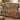 Bloodroot Trout Lily woven blanket draped over a sofa in a warm living room