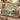 Painted Bunting Dogwood woven blanket draped over a sofa in a warm living room