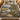 Buttonbush Mill Race woven blanket spread across a bed in a cozy bedroom