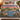 Everglades Spoonbill Dusk woven blanket spread across a bed in a cozy bedroom