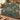 Dog Rose Cowslip woven blanket draped over a sofa in a warm living room