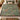 Comfrey Lungwort woven blanket spread across a bed in a cozy bedroom