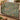 Comfrey Lungwort woven blanket draped over a sofa in a warm living room