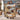 Personalized The Paths We Shared pet memorial woven blanket with custom photos and the name BAILEY, held up by a couple in a living room