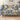 Porcelain Blue Garden: Blue-and-ivory floral woven blanket on a sofa with six name patches and a Nana plaque reading "You make every day bloom."