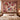 Personalized Rosewood Keepsakes Christmas patchwork woven blanket with sample family name hung as a wall tapestry above a bed