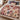 Rosewood Keepsakes Christmas patchwork woven blanket in rosewood and dusty pink spread across a bed