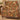 Terracotta Acanthus Hearth Morris Style woven blanket draped over an armchair