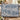 Garden Folly Blue woven blanket draped over a sofa in a warm living room