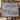 Couple holding a personalized Garden Folly Blue woven blanket with custom family name
