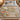 Moon Snail Dune Garden woven blanket spread across a bed in a cozy bedroom