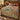 Maypop Trumpet Vine Morris Style woven blanket spread across a bed in a warm bedroom