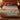 Platte River Sandhill Crane woven blanket spread across a bed in a warm bedroom