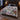 Alpine Ibex Christmas woven blanket spread across a bed in a Christmas bedroom