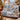 Alpine Ibex Christmas woven blanket draped over a sofa in a holiday living room