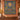 Balloon Valley Sun Medallion woven blanket displayed as a wall tapestry on a terracotta wall above a wooden console