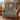 Balloon Valley Sun Medallion woven blanket draped over a leather armchair