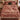 Red and cream Christmas tree farm pattern woven blanket spread on a bed