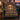 Bat Harvest Moon Medallion woven blanket draped over a teal armchair