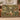 Personalized Secret Garden Almanac woven blanket draped over a cognac leather sofa