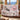 Black Bear Huckleberry Luxe woven blanket draped over a sofa in a living room