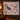 Black Bear Huckleberry Luxe woven blanket hanging as a wall tapestry in a cabin-style room