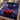 Personalized neon night race car spider boy photo blanket laid on a kids bed