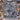 Blue Cream Hanukkah Story woven blanket displayed outdoors in a snowy stone courtyard with lanterns