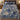 Blue Cream Hanukkah Story woven blanket spread on a bed with blue and cream pillows